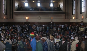 Refugees inside Germiston City Hall wait patiently for assistance.